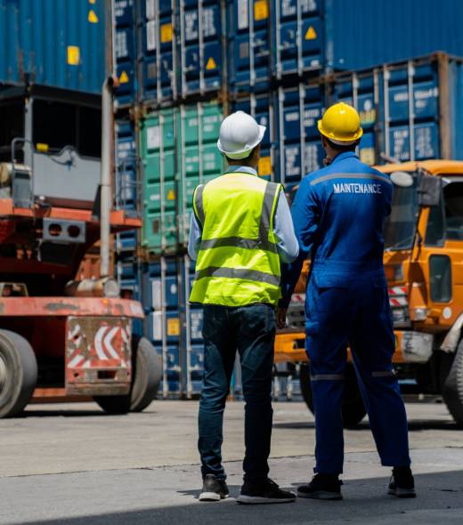 Foreman checking and control loading containers. Working in cargo container warehouse industry factory site in export, import, and transportation concept.