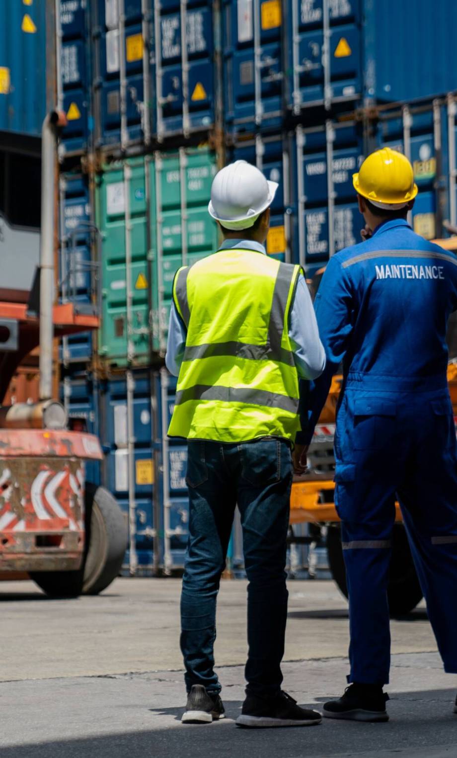 Foreman checking and control loading containers. Working in cargo container warehouse industry factory site in export, import, and transportation concept.